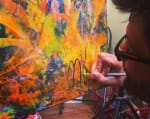 Abstract painter L.A. Artist Nestor Toro signing a finished painting