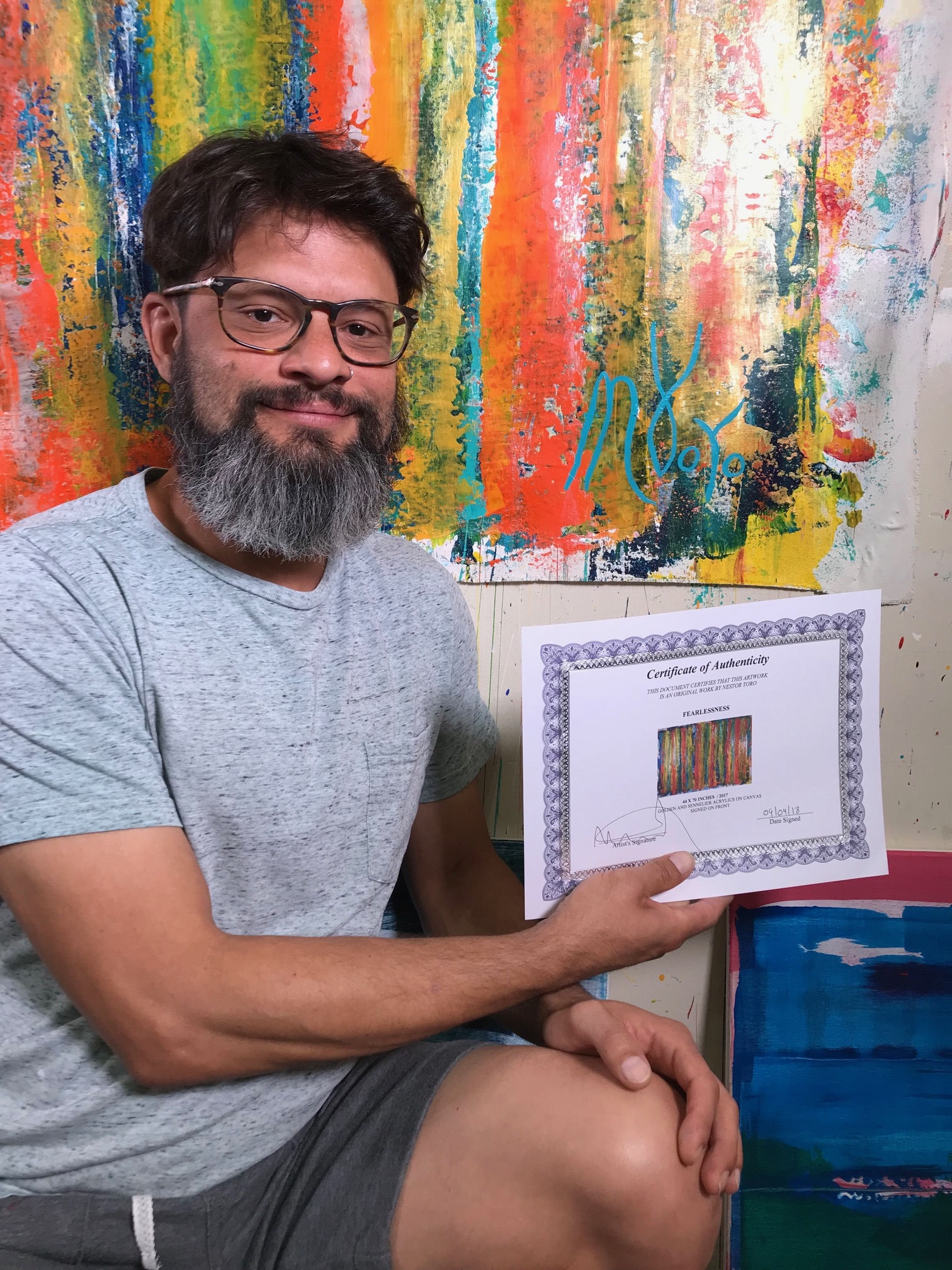 Artist Nestor Toro signing his work entitled Fearlessness