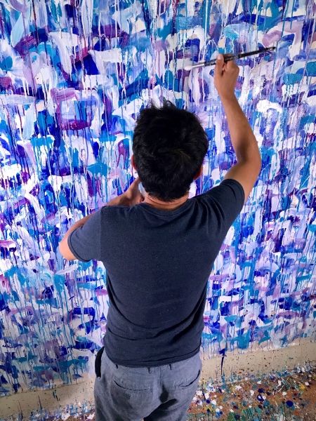 Artist Nestor Toro working on the painting