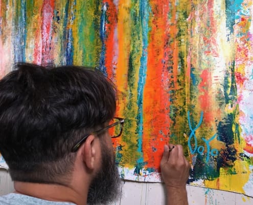 Artist Nestor signing his work "Fearlessness" Artist Nestor signing his work "Fearlessness"